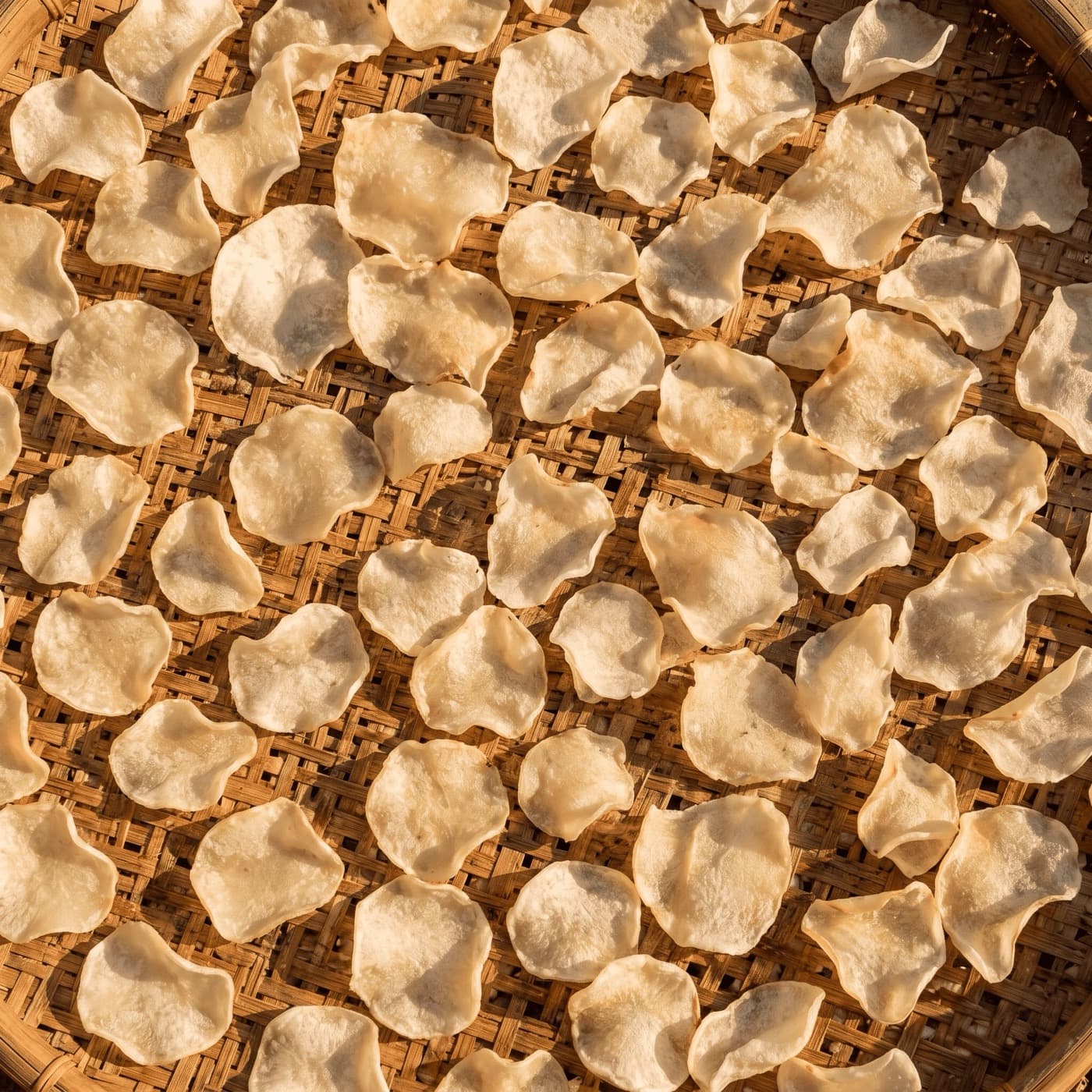 Sun-dried potato slices on a bamboo tray